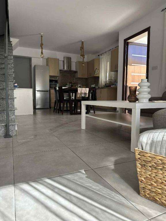 a kitchen and dining room with a white table in a room at Aphrodites Resident in Paphos