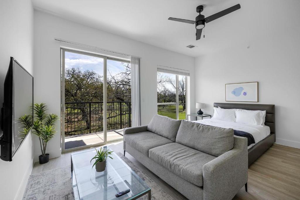 a living room with a bed and a couch at Landing Apartments - Denton in Denton