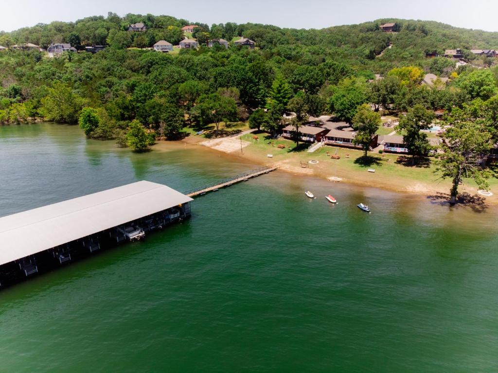 an aerial view of a beach with a dock in the water at Happy Hollow Resort in Blue Eye