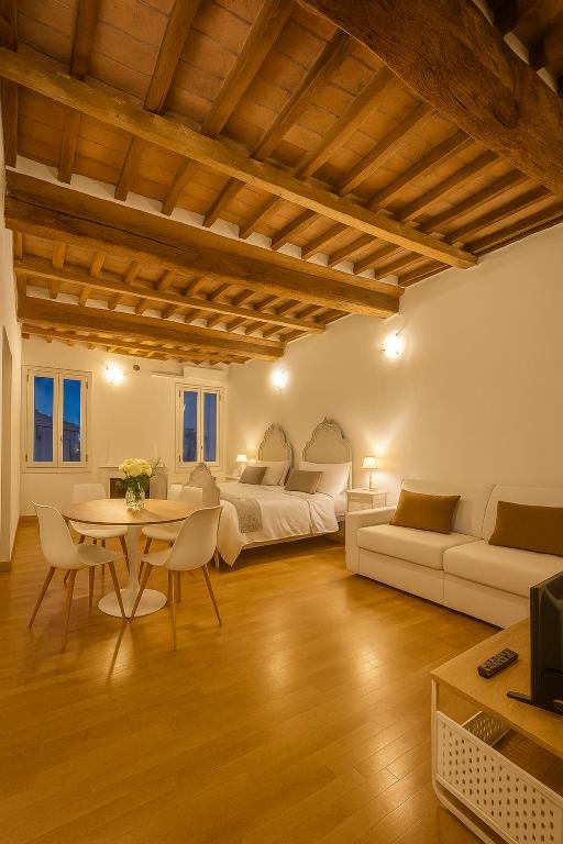 a living room with white furniture and a table at appartamento Ferraresi in San Felice sul Panaro