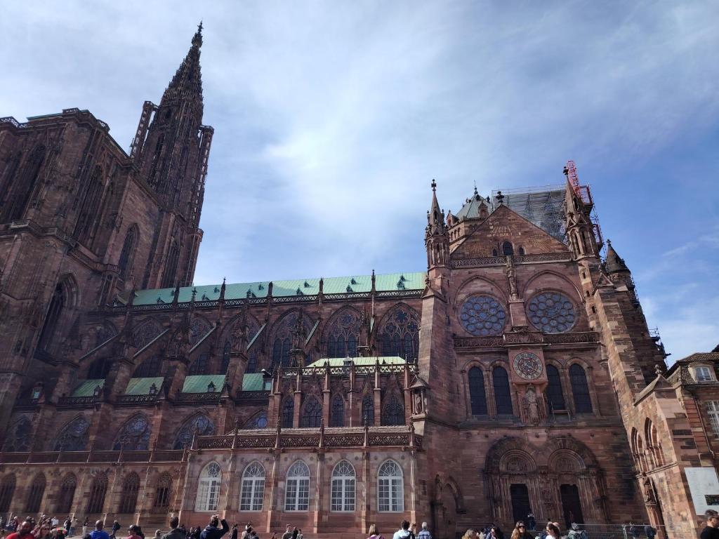 a large cathedral with people standing in front of it at Au Chat l'Heureux in Mackenheim