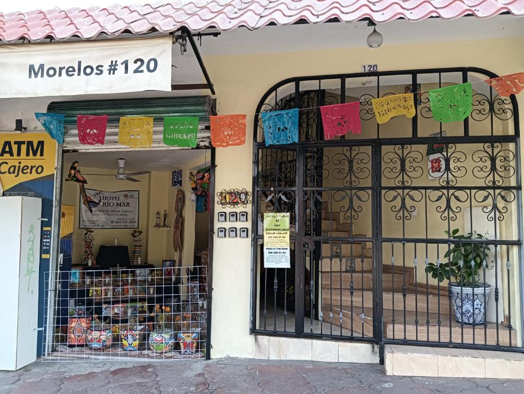 a store with a gate in front of a store at hotel rio mar in Puerto Vallarta