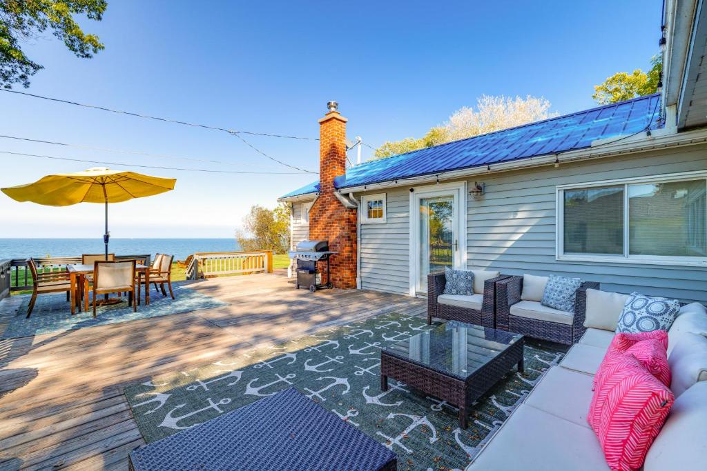 a patio with a couch and a table and an umbrella at Wilson Waterfront Getaway Near Hikes and Wineries! in Wilson