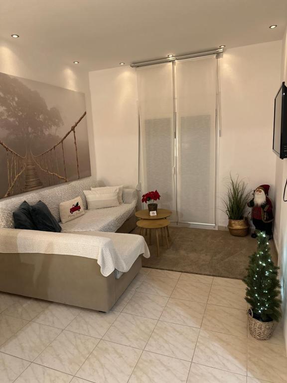 a room with a bed and a christmas tree in it at Villa Niki in Vrasná