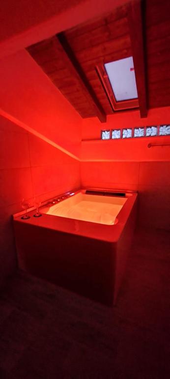 a red room with a bath tub with at La rosa rossa in San Gemini