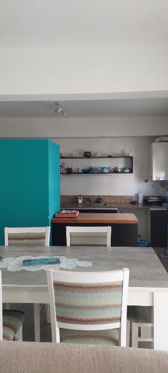 a kitchen with a table and chairs in a room at Departamento Pepper in Trelew