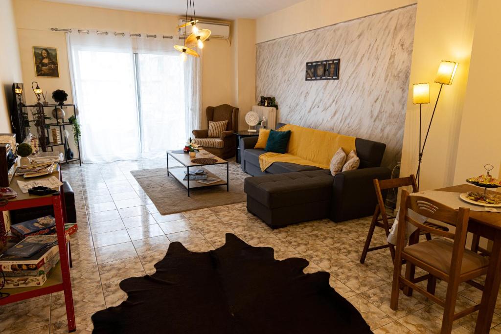 a living room with a couch and a table at Comfort Zone - Spacious Apartment in Xanthi in Xanthi