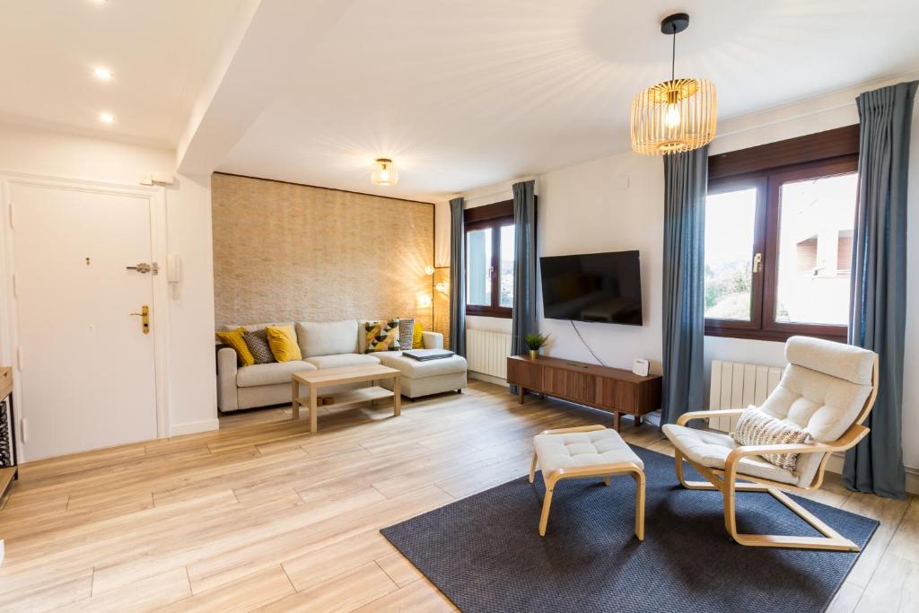 a living room with a couch and a tv at Etxea iradi in Elejalde
