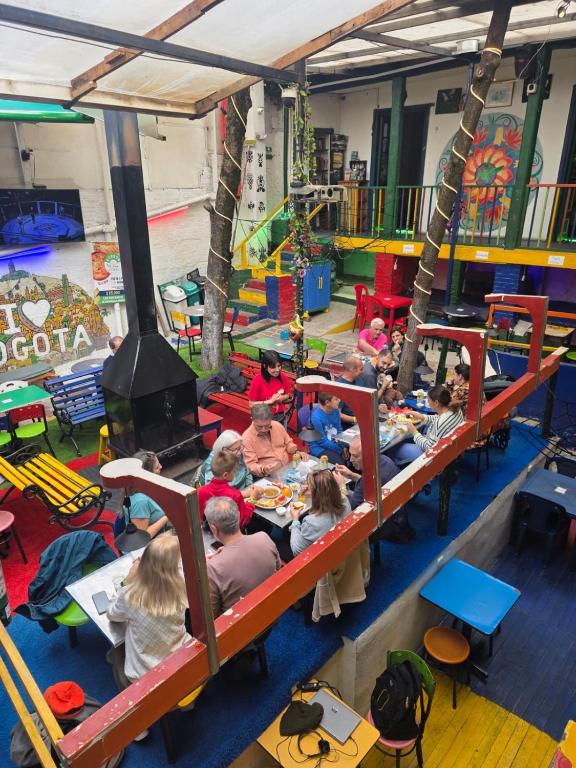 a group of children sitting on bunk beds in a room at Hostal Gastro Bar Casa Colibrí in Bogotá