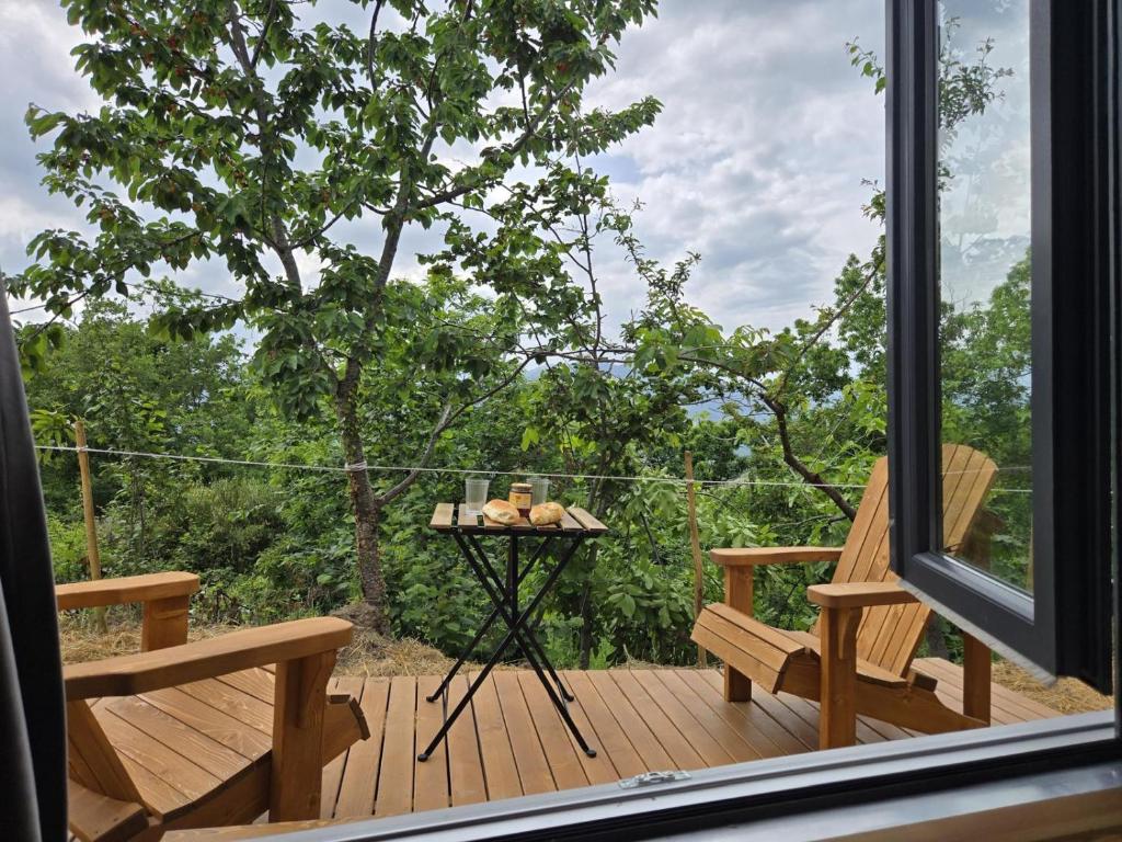 a view of a deck with a table and benches at In the Wild Volcano Sea Side 