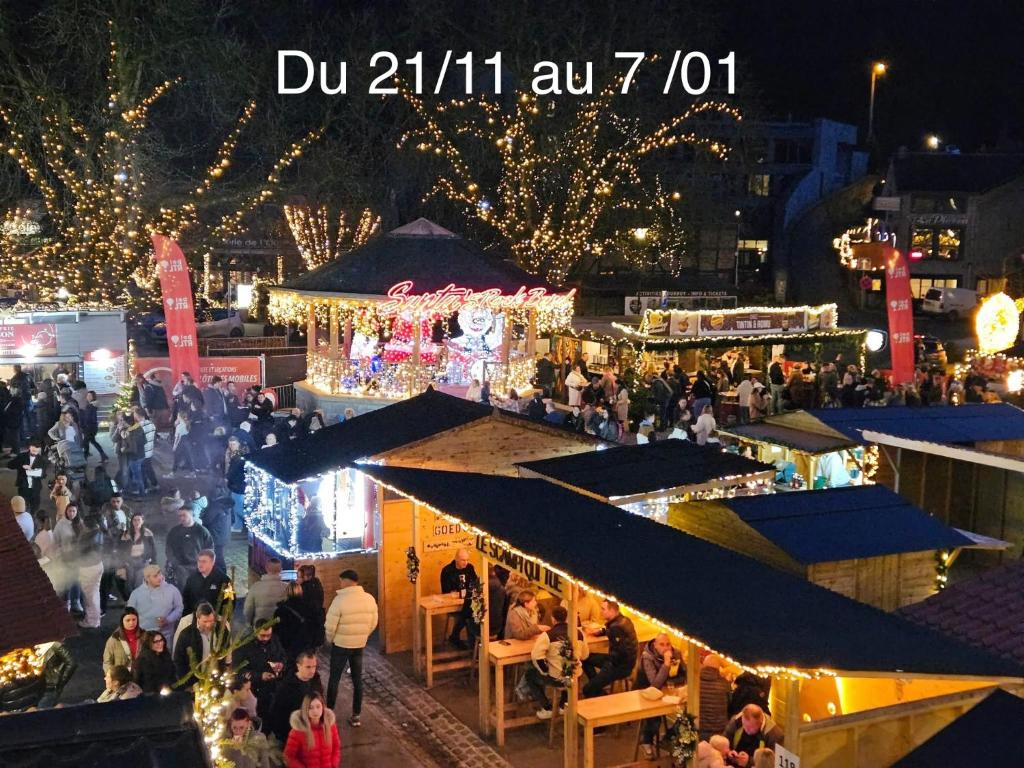 a crowd of people walking around a market at night at Le Lantigné in Durbuy