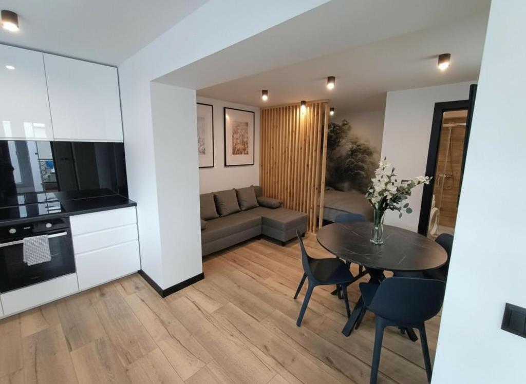 a living room with a table and a couch at "Work and Quiet", Faktura VAT, KLIMATYZACJA, AIR CONDITIONING, GROUND FLOOR, PARKING, PARTER, in Kielce