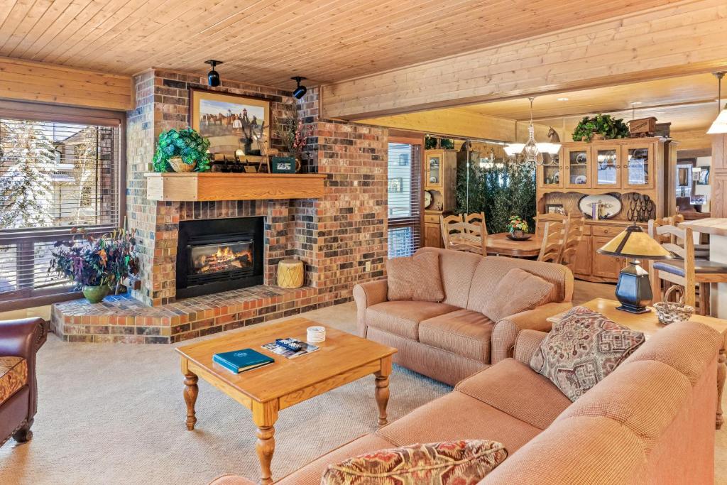 a living room with a couch and a fireplace at Dulany 306 in Steamboat Springs