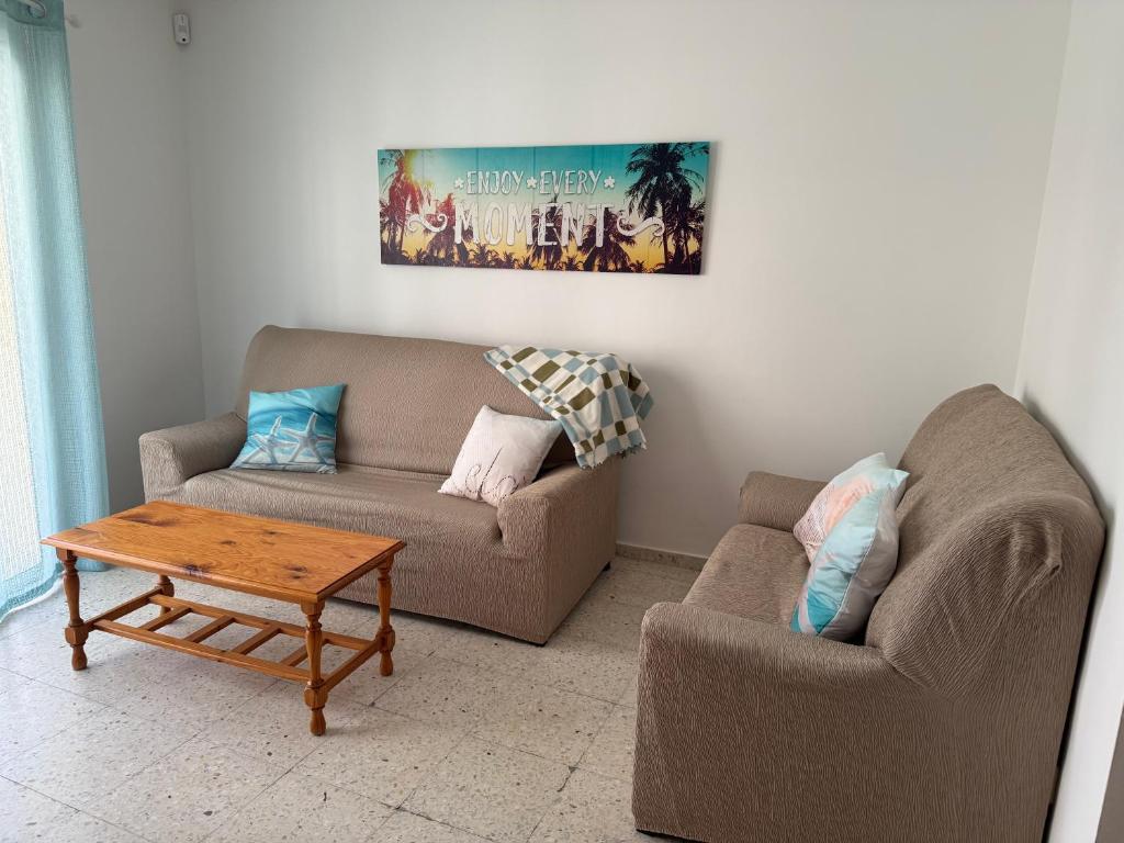 a living room with a couch and a coffee table at Casa Sole in El Médano