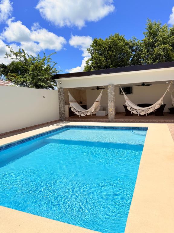 a swimming pool in front of a house at Serenity House Antón in Coclé