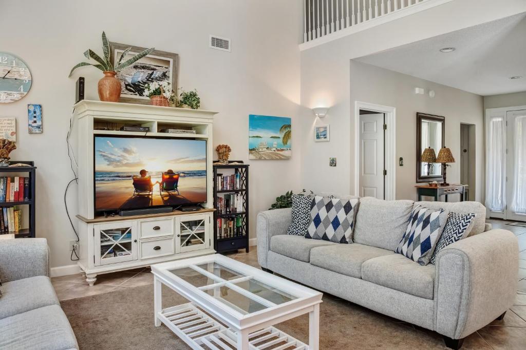 a living room with a couch and a tv at Turnberry 8573 in Destin