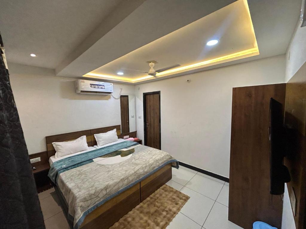 a bedroom with a bed and a tv in it at The Royal palace hotel in Phalodi