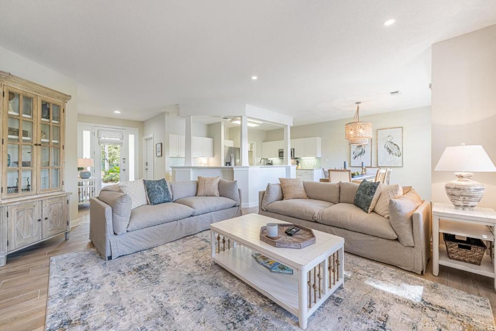 a living room with two couches and a table at Turnberry 8561 in Destin