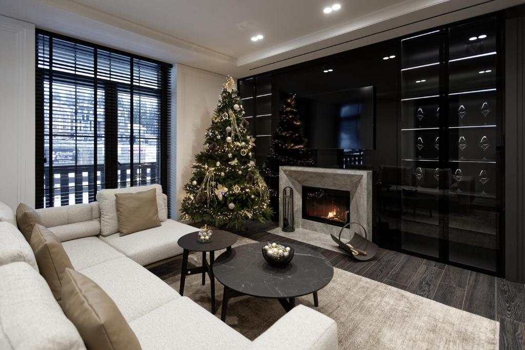 a living room with a christmas tree and a white couch at Cristal Garden Chalet in Bukovel