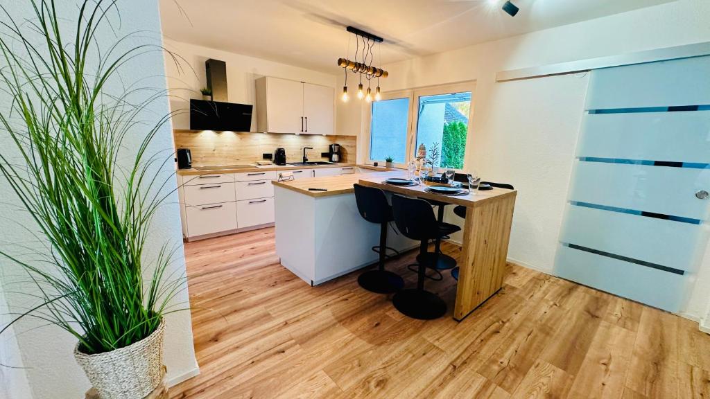 a kitchen with a wooden island in a room at T&P FamilyHaus in Bad Sooden-Allendorf