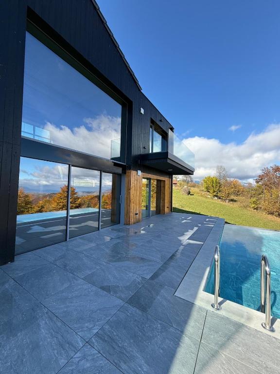 an external view of a house with a swimming pool at Nordic Star Chalet in Fundata