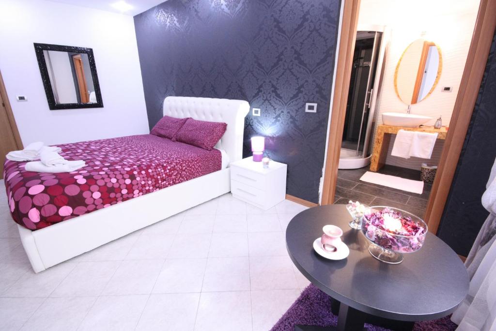 a bedroom with a bed and a table and a mirror at Black and White in Cantù