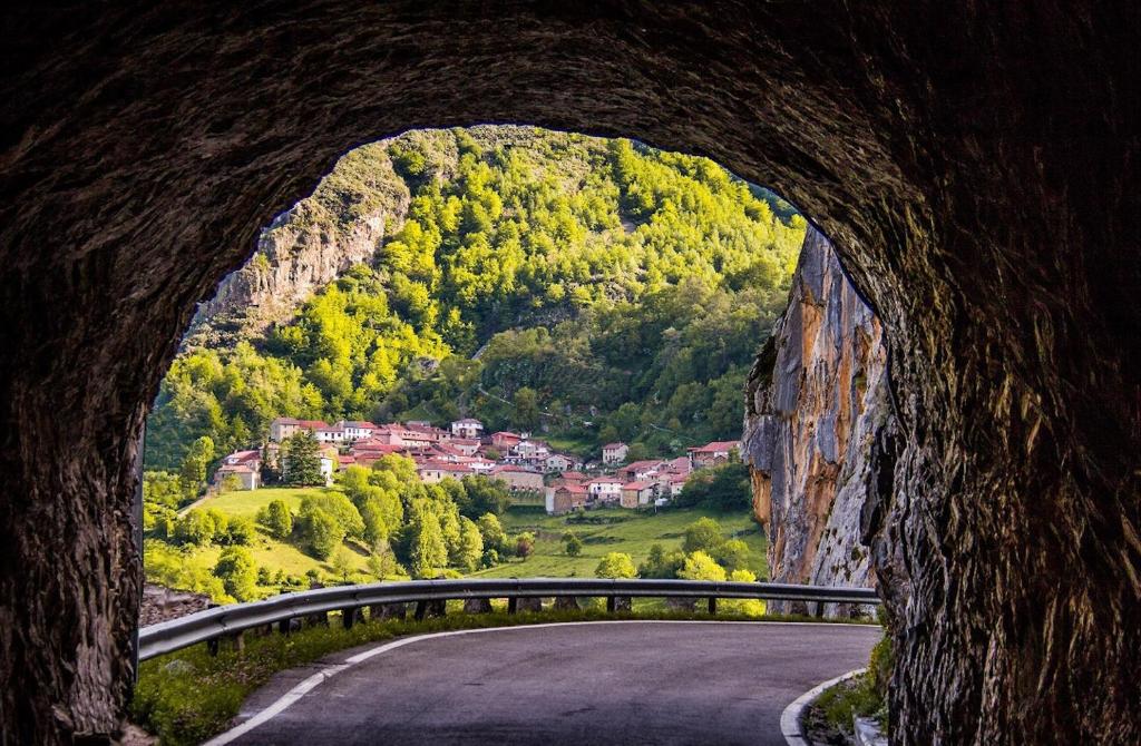 a road going through a tunnel in a mountain at Viviendas Rurales El Cantón in Cucayo