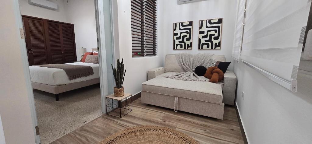a living room with a couch and a bed at Boho Chic Relaxing Space in Fajardo
