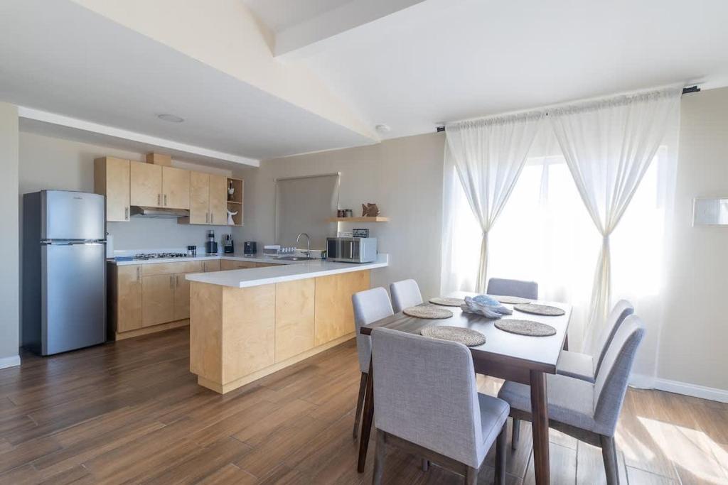a kitchen and dining room with a table and chairs at New Casa Marea #2 Beach Front House 2BR Wifi AC in Colonia Cuauhtemoc