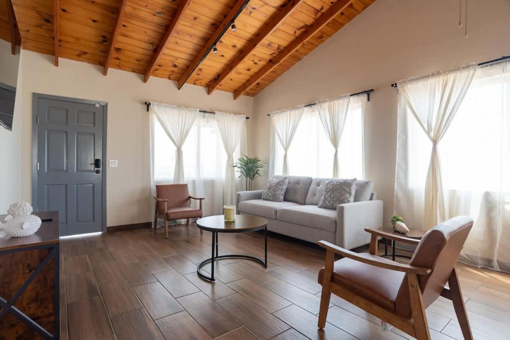 a living room with a couch and a table at NEW Casa Marea Beach Front House DT 2BR WiFi & AC in Colonia Cuauhtemoc