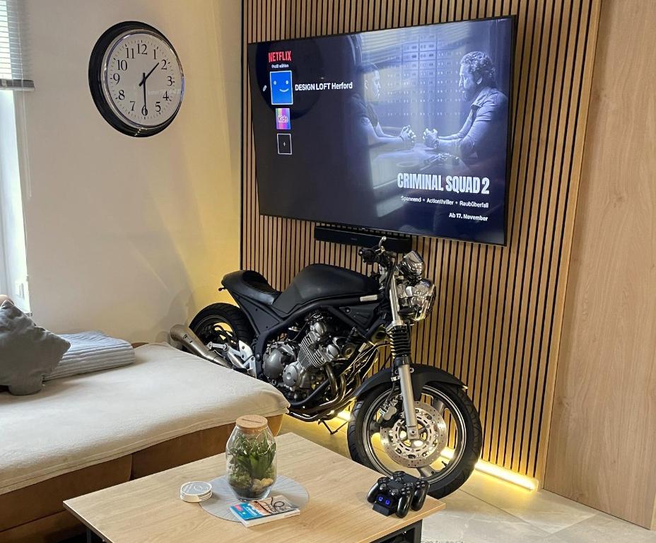 a motorcycle parked in a room with a tv at DESIGN LOFT Herford - Parkplatz, WLAN, Netflix, PS4, Heimkino in Herford