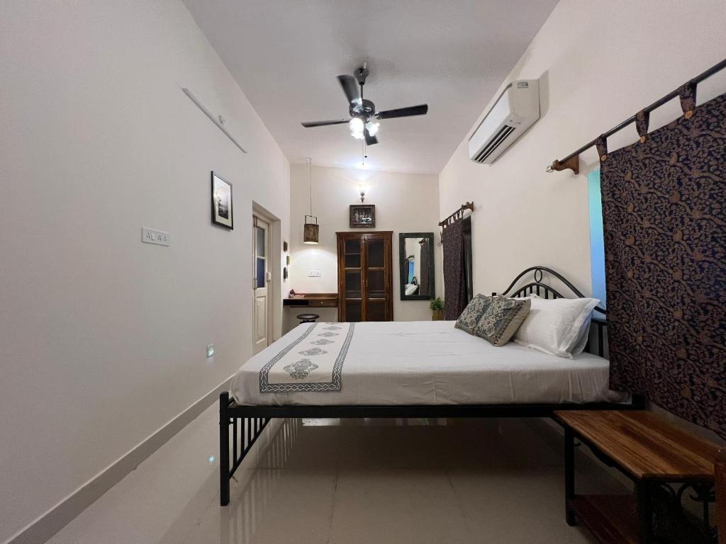 a bedroom with a bed and a ceiling fan at A Heritage Homestay in Jodhpur