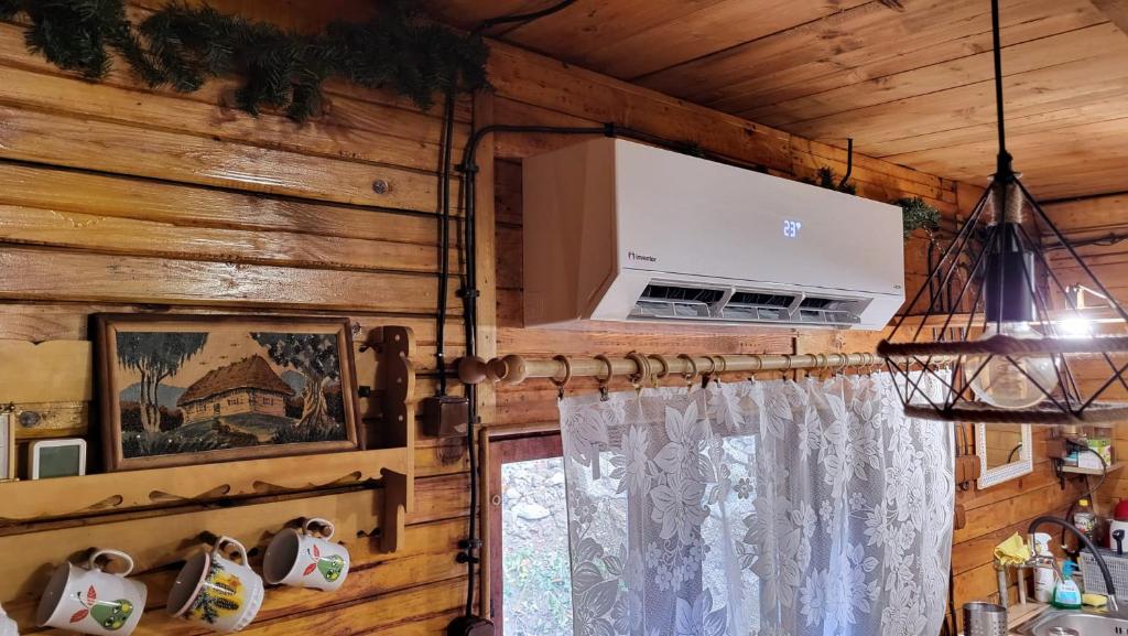 a room with a wooden wall with a window at Chata Jozef in Sabinov