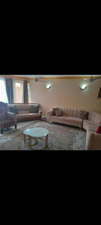 a living room with couches and a coffee table at Nyali BnB Apartment in Mombasa