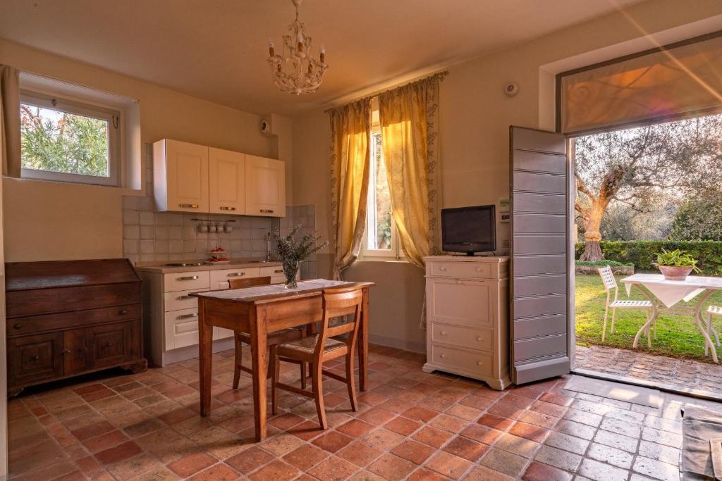 a kitchen with a table and chairs and a window at Marica in Pesaro