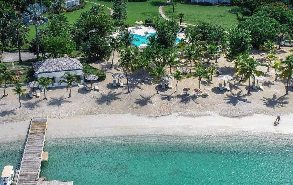an aerial view of a beach with a resort at The Inn at English Harbour in English Harbour Town