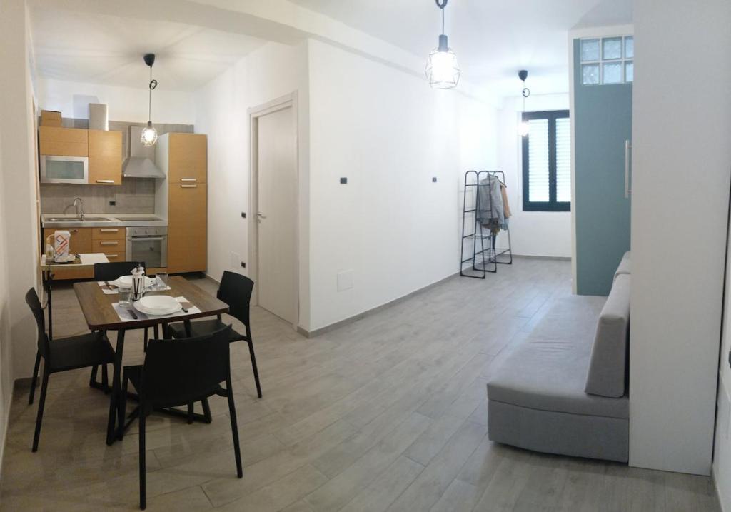 a living room and kitchen with a table and chairs at Home 56 vacation home in Salerno