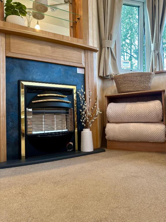 a living room with a fireplace with a blue wall at East Coast in Port Seton