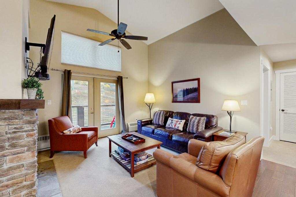 a living room with a couch and two chairs at Base Camp One 403 in Granby