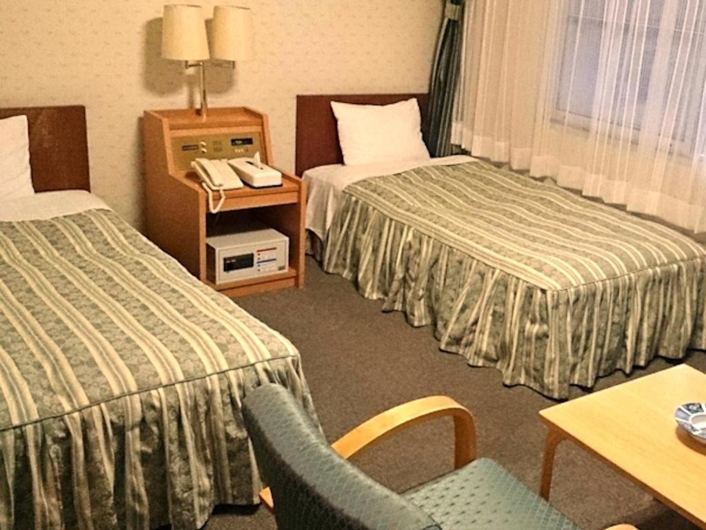 Postel nebo postele na pokoji v ubytování Hotel Axia Kushikino