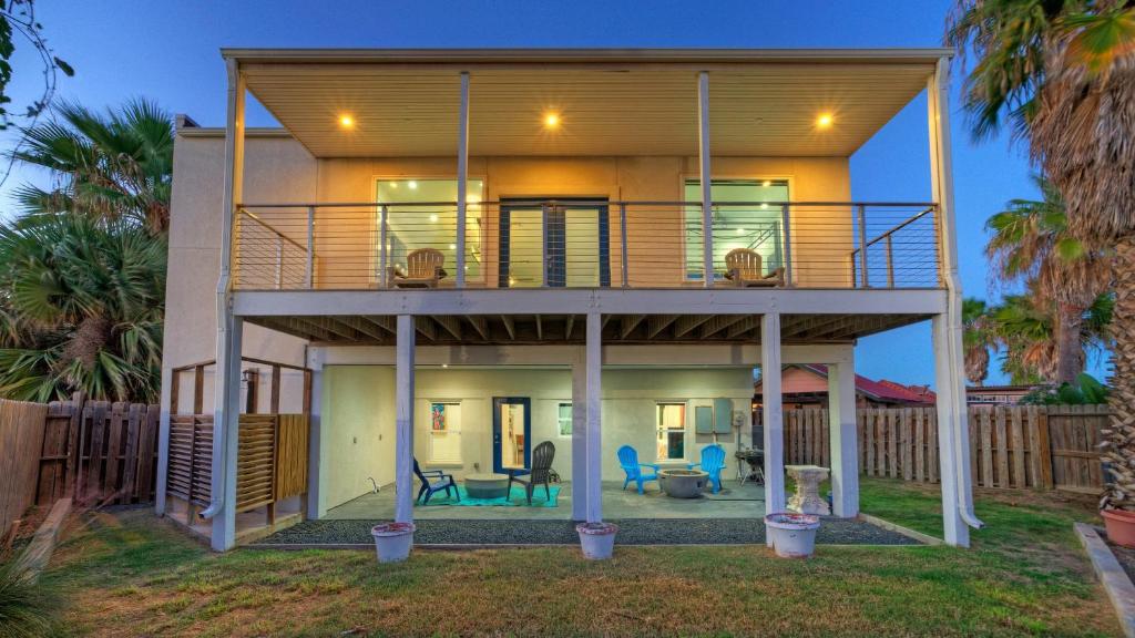 a large house with a deck and a patio at Modern Coastal Home w Balcony Views Firepit Prime Port A Location Casa Blanca by AvantStay in Port Aransas
