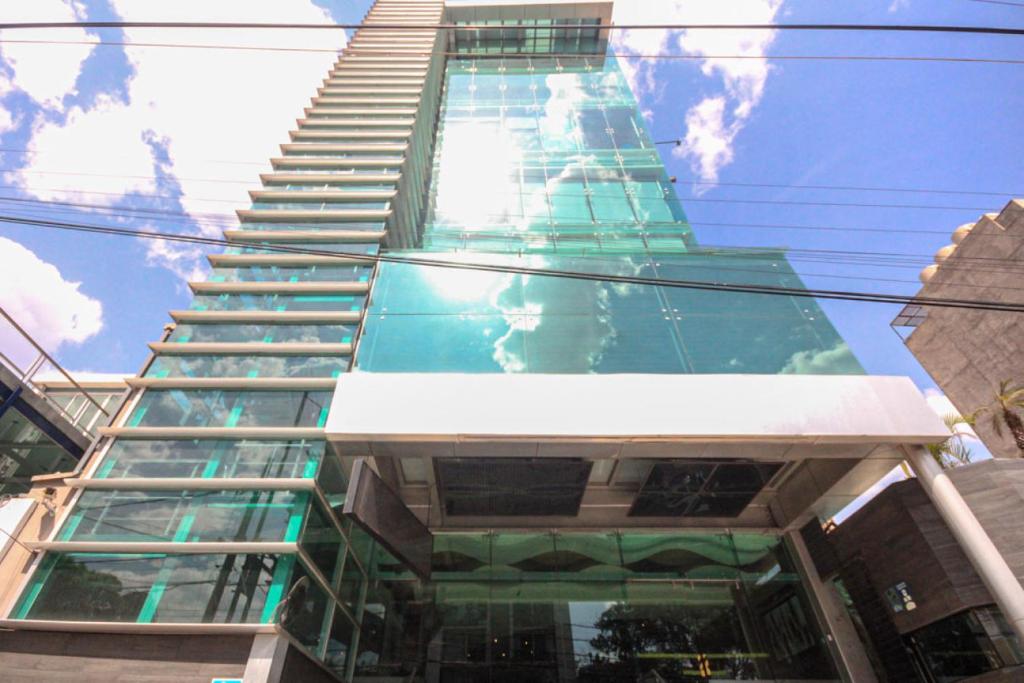 a tall green skyscraper with a staircase up to it at The Midnight Bloom Suite in Mexico City