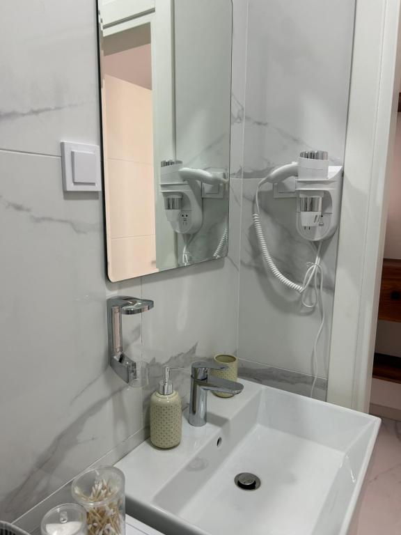 a bathroom with a white sink and a mirror at Patrinia in Vrijesno