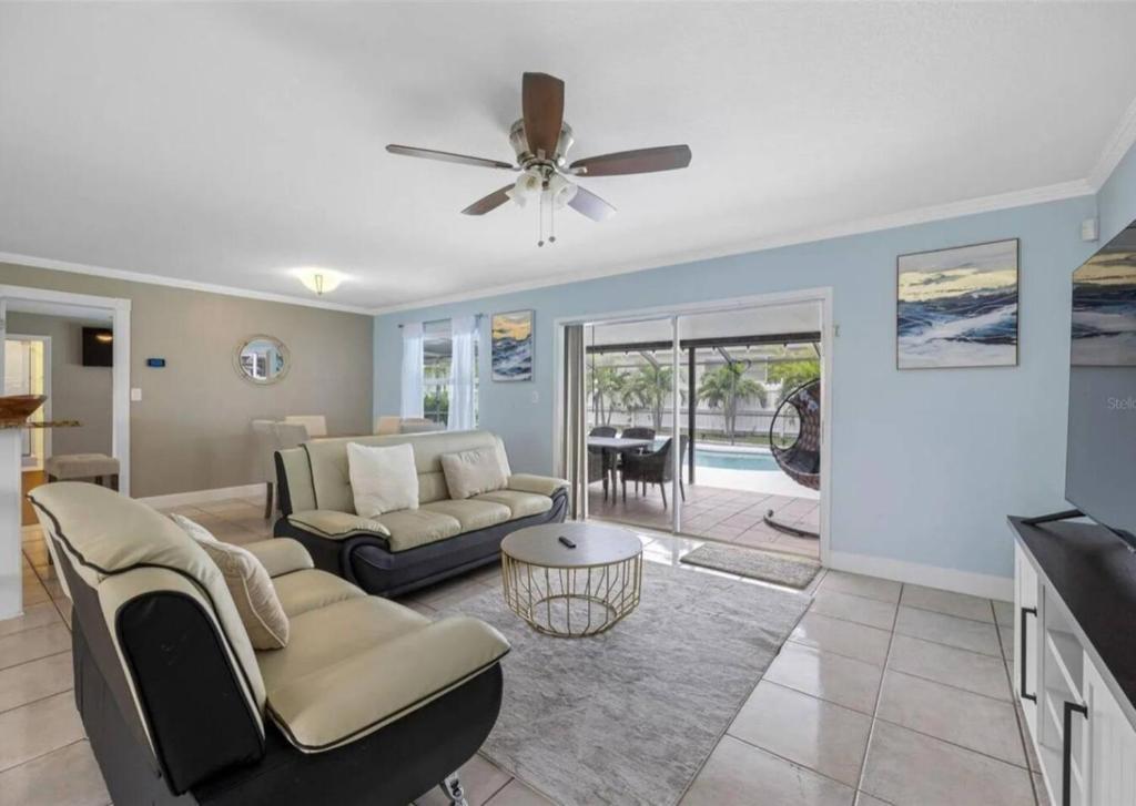 a living room with a couch and a ceiling fan at Villa W pool in Clearwater in Clearwater