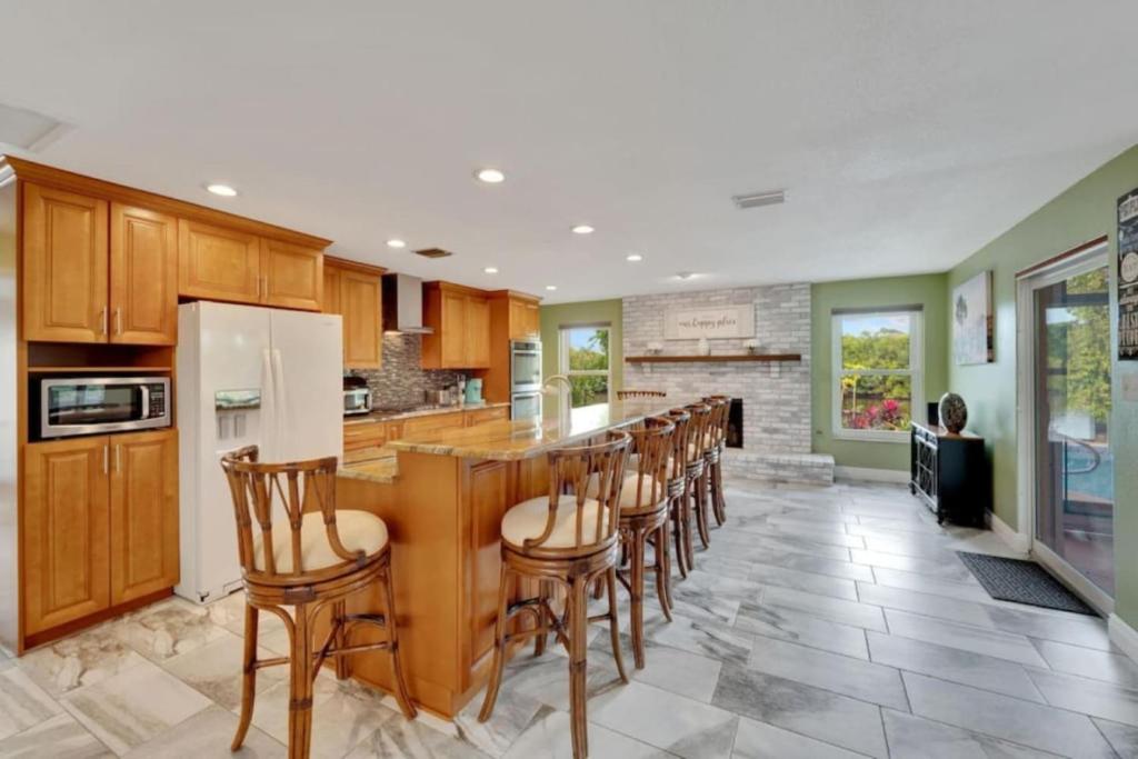 a kitchen with a bar with wooden stools at Water front in Clearwater in Clearwater