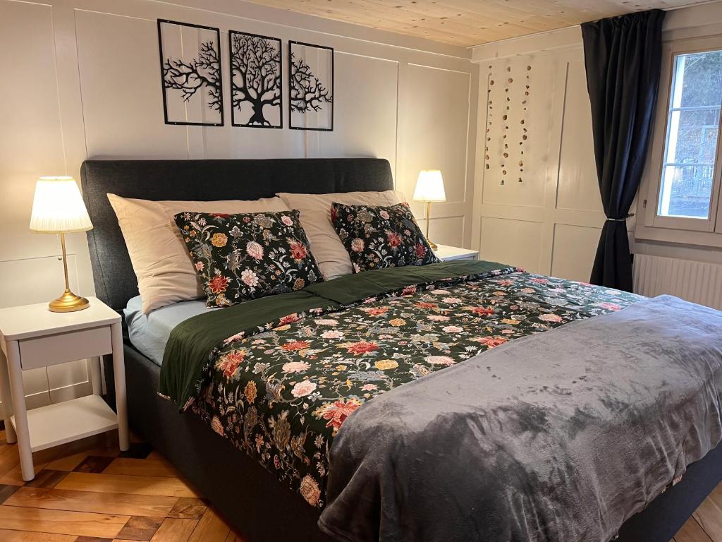 a bedroom with a bed with a blanket and pillows at Dammablick Göschenen in Göschenen