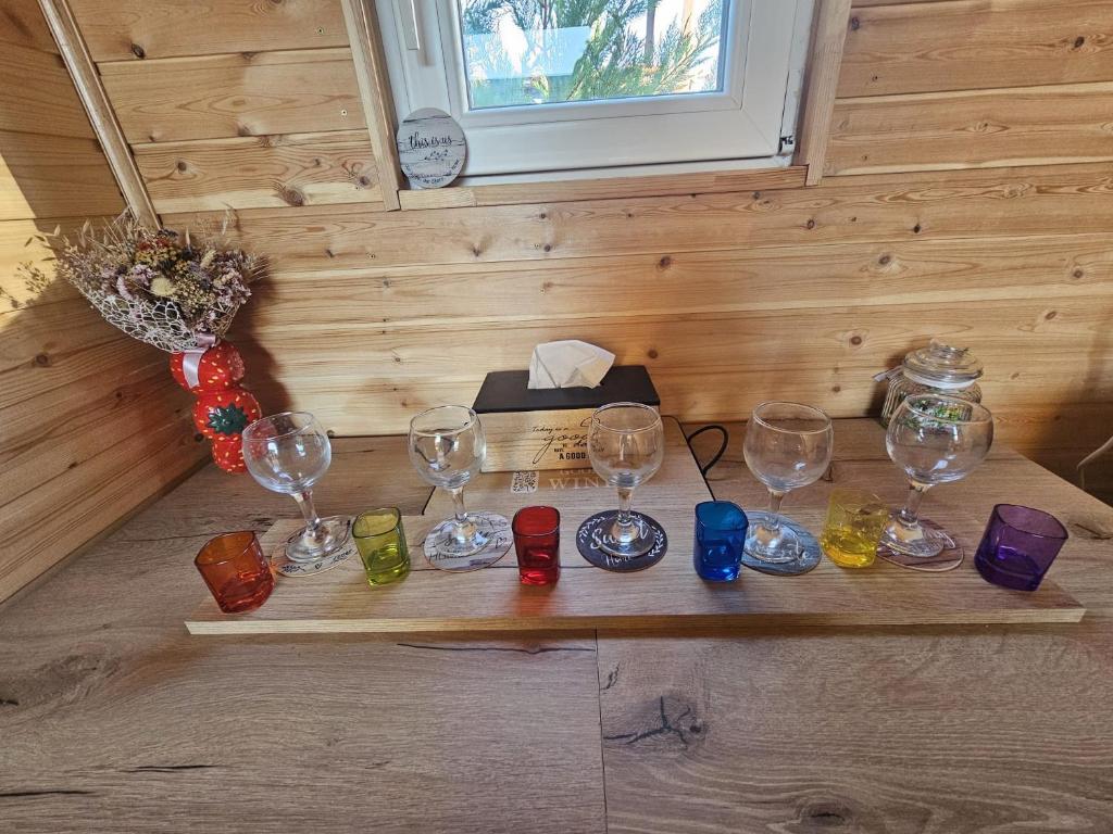 a group of wine glasses sitting on a wooden table at A Frame la Iaz in Mărăcineni