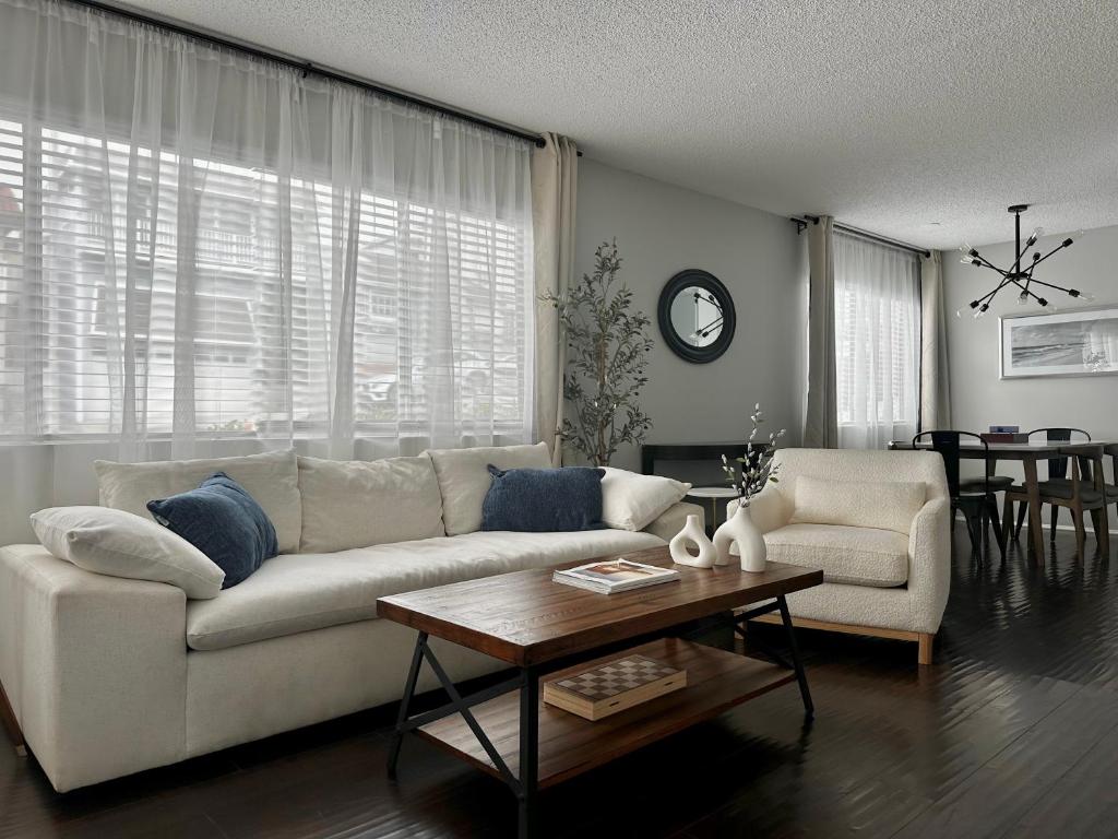 a living room with a white couch and a table at The Nest Manhattan Beach, Partial Ocean View in Los Angeles