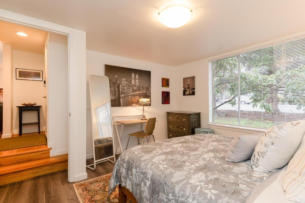 a bedroom with a bed and a window and a desk at Spacious Retreat 3 Miles to Airport 12 to Seattle in Burien