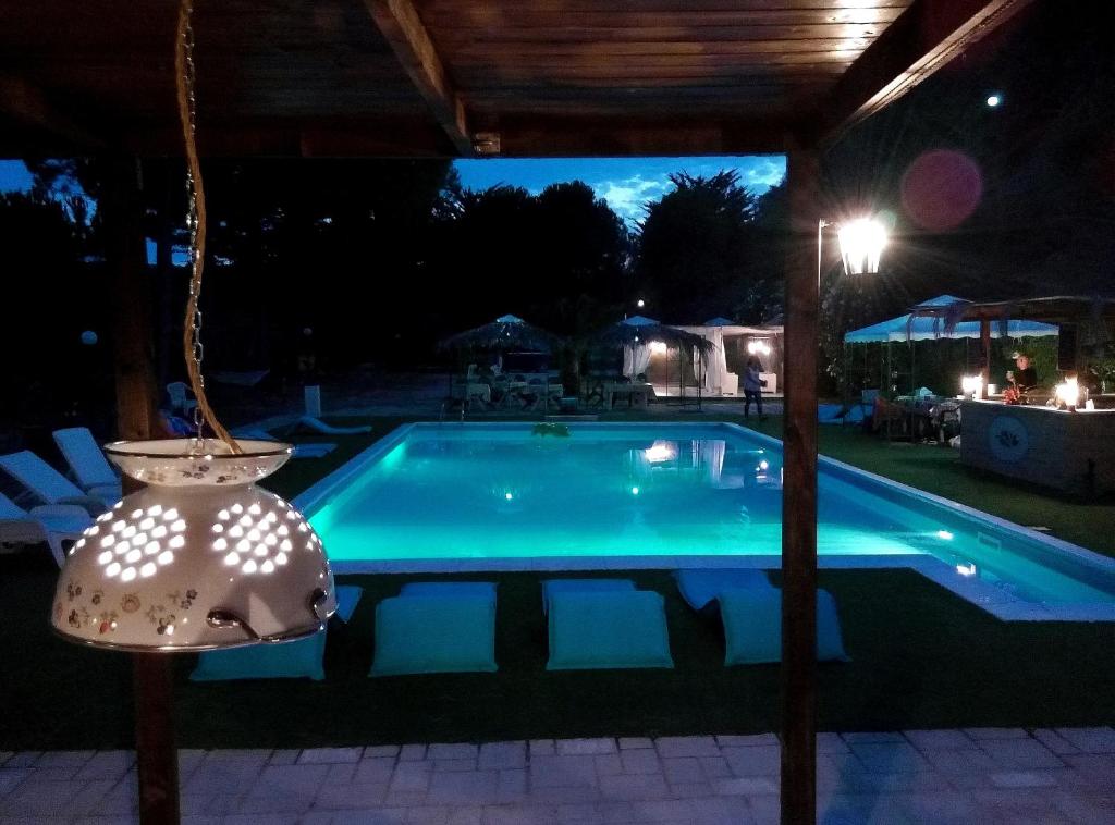 a swimming pool at night with a light at Il Corbezzolo in Ripatransone